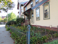 red house century home, black wrought iron fence and horses head made of the black iron, image taken in ohio city neighborhood by nancy gurish